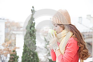 The girl in the hat froze and drinking hot tea
