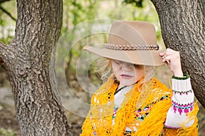 Girl with hat and orange pelerine in autumn season photo