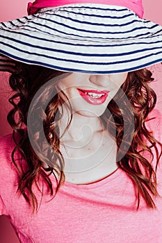 The girl in the hat on a pink background pinup