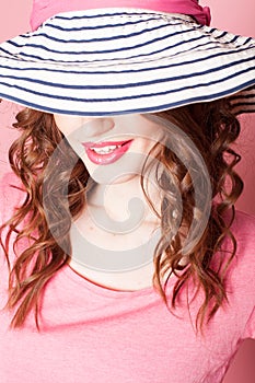 The girl in the hat on a pink background pinup