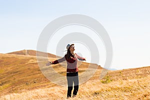 Girl with hat walk with happiness on top of mountain range in autumn