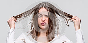 Girl having a bad hair. Bad hairs day. Frustrated woman having a bad hair. Woman having a bad hair, her hair is messy