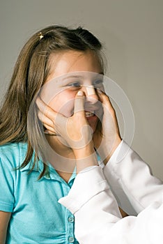 Girl Having Band-Aid Applied to Nose.Vertical
