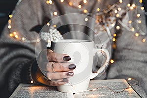 Girl having a break with cup of fresh coffee after reading books or studying.