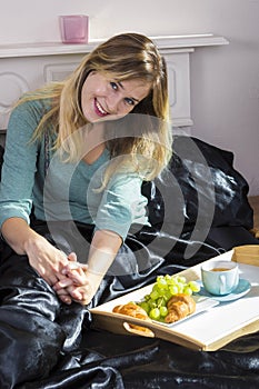 Girl having breakfast in bed