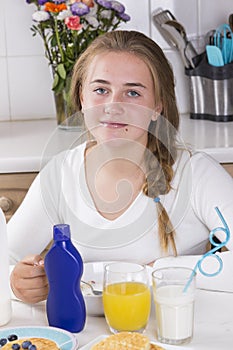 Girl having breakfast in kitchen