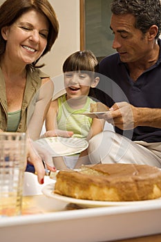 Girl having cake with grandparents