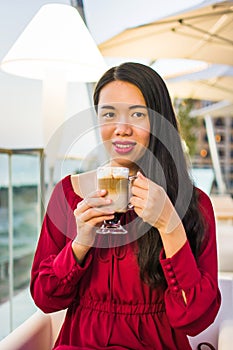 Girl having a cup of coffee in a bar