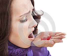 Girl having flu taking pills