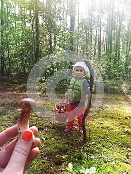 Girl having fun in an autumn forest with her family