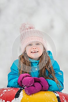 Girl having fun on snow tube.Girl is riding a tubing