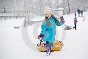 Girl having fun on snow tube. Girl is riding a tubing