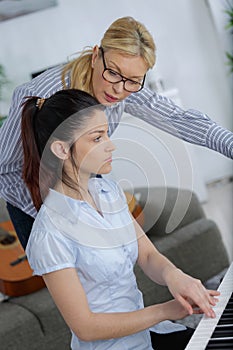 Girl having piano lesson