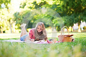 Girl having a picnic and writing in her diary