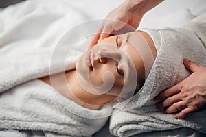 Girl having spa facial massage in luxurious beauty salon