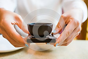 Girl having tea at Chinese restaurant