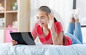 Girl having vide call on tablet computer at home