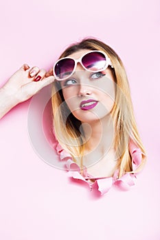 girl head in cardboard hole, young woman lifted her sunglasses planning summer holidays and thinking about offer of hot vouchers,