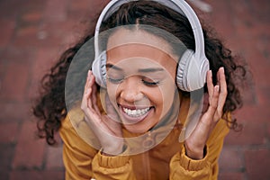 Girl, headphones and listening to music outdoor with inspirational, wellness and mental health podcast. Happy young