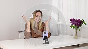 Girl in headphones listens to music emotionally.