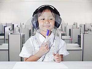 Girl with headphones in multimedia room