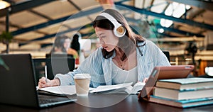 Girl, headphones and student writing at college, study and research for assignment or essay. Woman, learning and