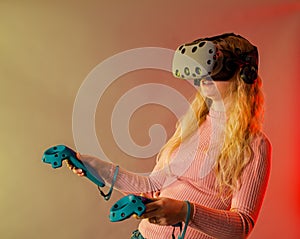 Girl in headset of vr virtual reality play game with joystick