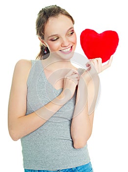 Girl with a heart-shaped pillow