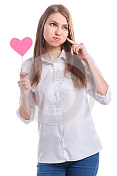 Girl with heart on stick is touching puffed cheeks on white background