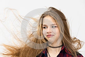 Girl with heavily flowing hair on white background