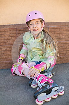 Girl in a helmet and the protection of the hands