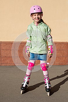 Girl in a helmet and the protection of the hands