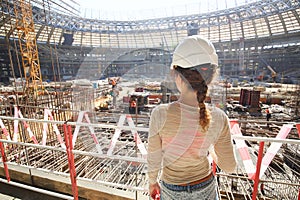 Girl in a helmet watching reconstruction of photo