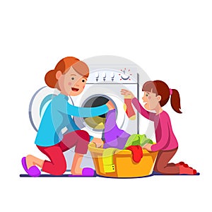 Girl help mum loading laundry to washing machine