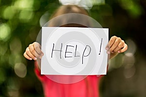 Girl with Help sign