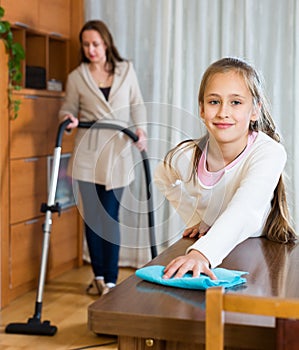 Girl helps mother to clean house