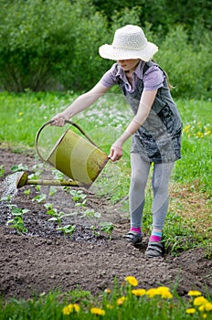 Girl helps pours garden
