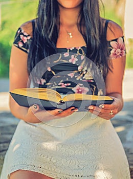 Girl and her book in the park