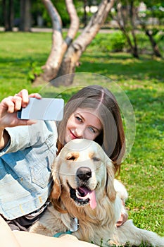 Girl and her dog selfie summer on a background of green grass
