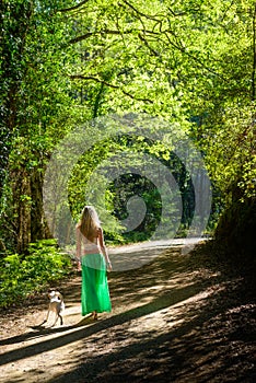 A girl and her dog walking along a hiking trail in the troodos mountains,cyprus