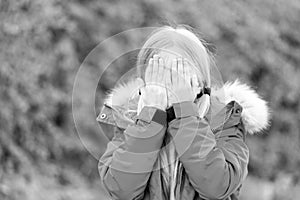 Girl hide face with hands on idyllic autumn day