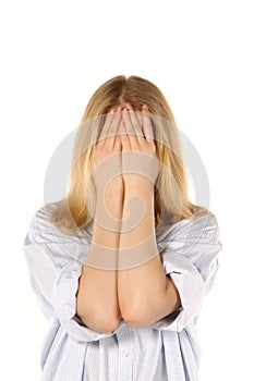 Girl hiding face behind her hands