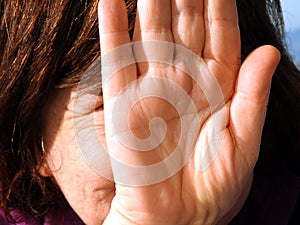 Girl hiding her face with her hand