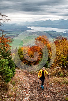 Girl hiker on autumn moutain trail