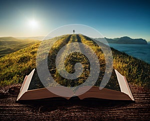 Girl hiker with backpack on the pages of book