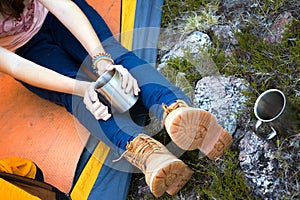 Girl hiker holding a cup