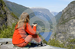 Girl hiker looking at the fjord