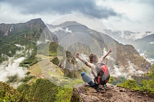 Girl-hiker looking on top of Huayna Picchu, looking on Machu Picchu