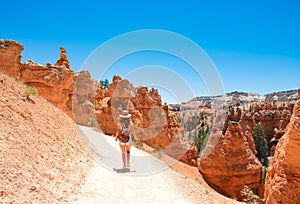 Girl hiking alone  in the  mountains on summer vacation.