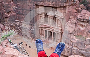 Girl hiking boots on Al-Khazneh background. Al-Khazneh (The Treasury) is beautiful temple in the ancient Nabatean city of Petra